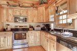 Antler Lodge - Kitchen with hickory cabinets and stainless steel appliances.